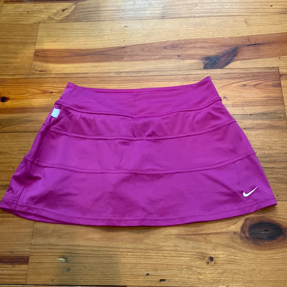 Women’s Nike tennis skirt with built-in spandex shorts , magenta color